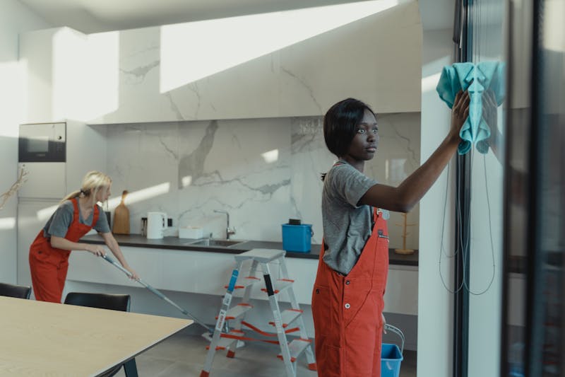 Professional cleaning team at work in a modern kitchen